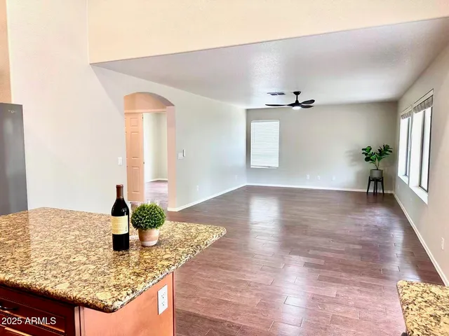 a kitchen with stainless steel appliances granite countertop a refrigerator and a stove top oven