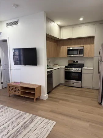 a kitchen with stainless steel appliances kitchen island granite countertop a stove and a sink