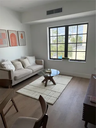 a living room with furniture and large window