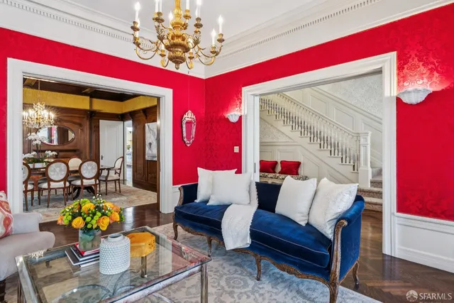 a living room with furniture and a chandelier