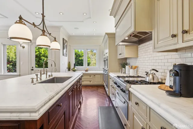 a kitchen with a sink stove and cabinets