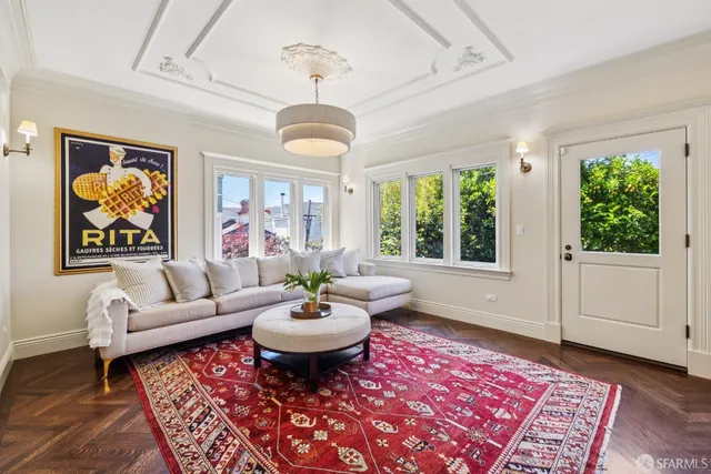 a living room with patio furniture and a potted plant