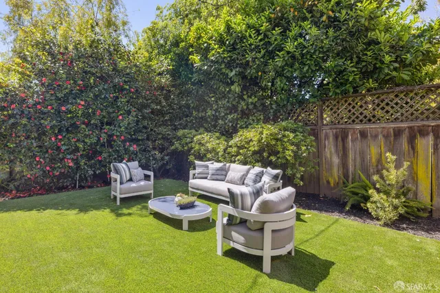 a view of a patio with couches chairs and a yard