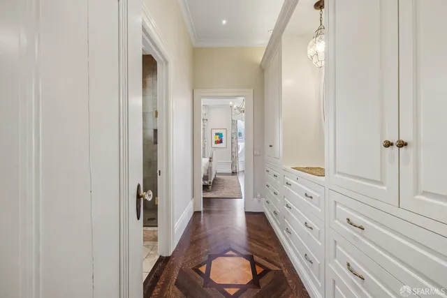 a bedroom with bed and a chandelier