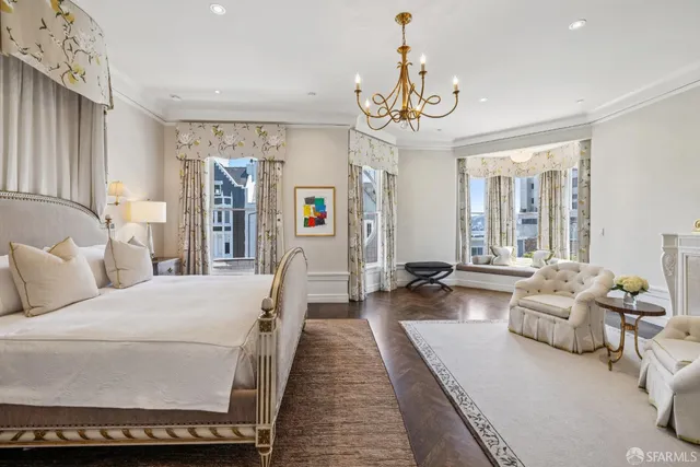 a bedroom with a bed mirror and window