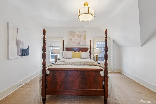 a bedroom with a bed chair and a window