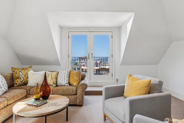 a view of a chairs and table on the roof deck