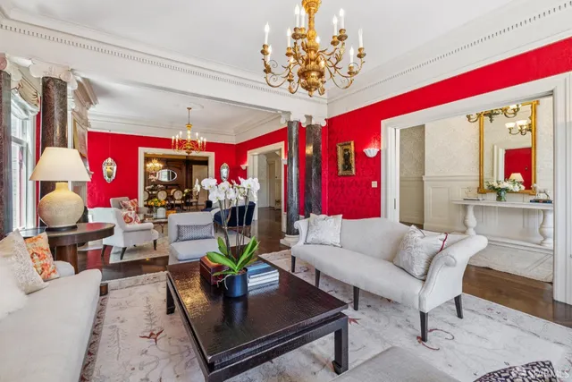 a living room with furniture and a chandelier