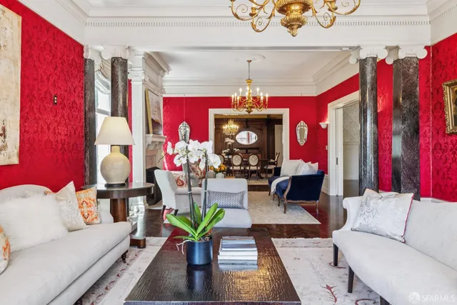 a living room with furniture kitchen view and a large window