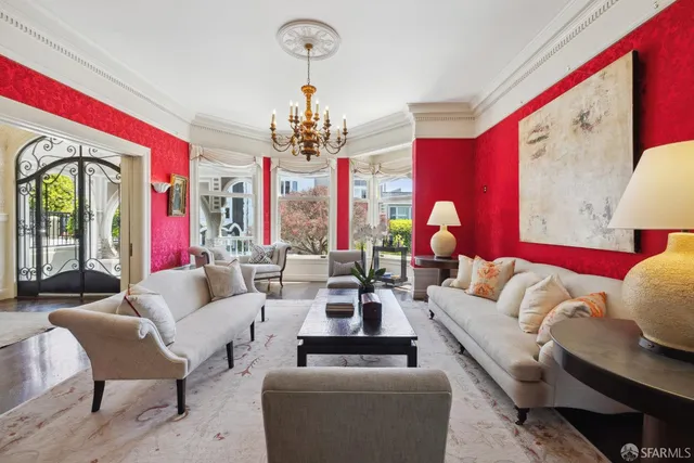a living room with furniture chandelier and a large window