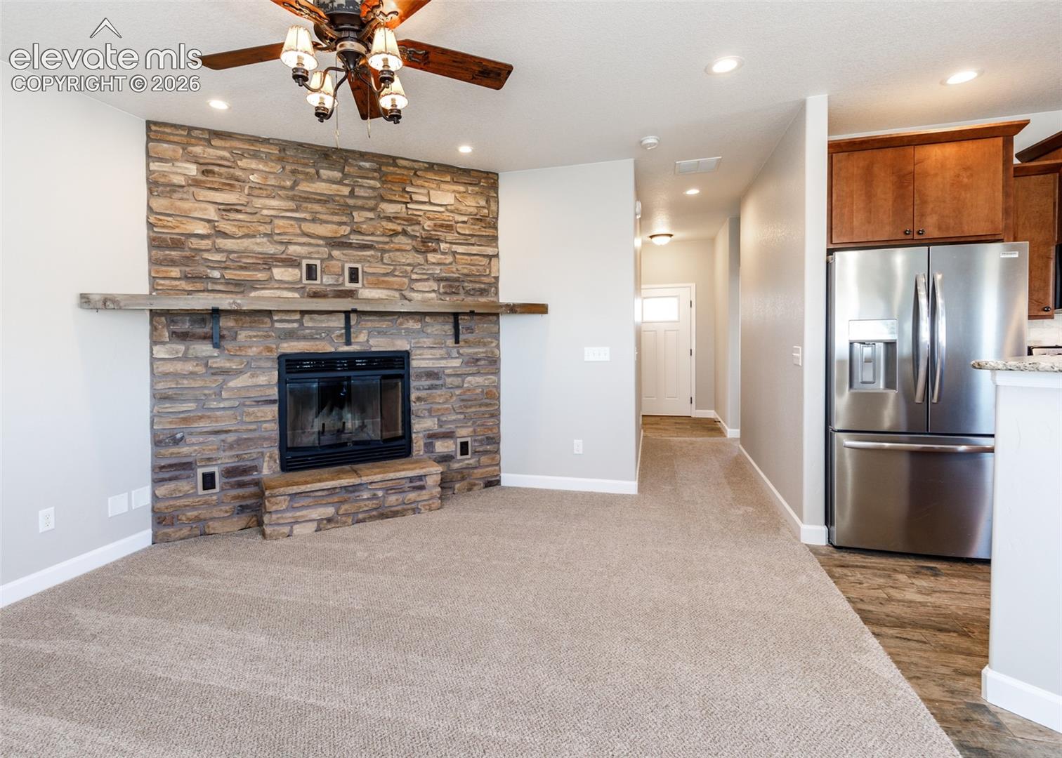 2105 Slocum Road Peyton, CO 80831 - Photo 6 of 26 Wood burning fireplace with stone surround warms the family room.