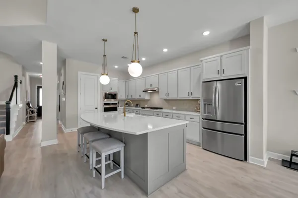 a kitchen with kitchen island a sink stainless steel appliances and cabinets