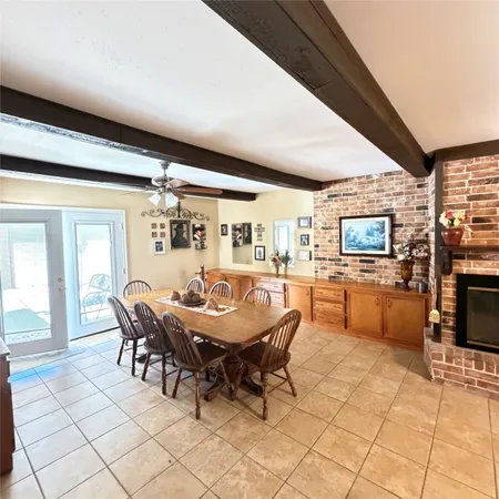 a dining room with furniture and wooden floor