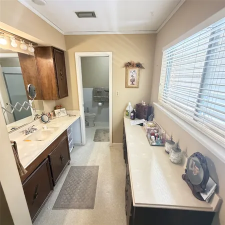 a spacious bathroom with a sink double vanity and mirror