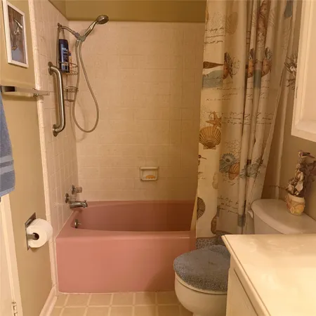 a bathroom with a granite countertop sink a toilet and shower