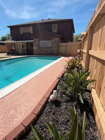 a view of swimming pool with a backyard