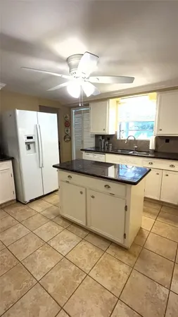 a kitchen with a sink a stove cabinets and counter space