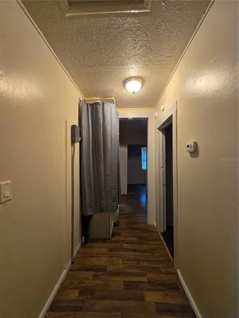 a view of a hallway with wooden floor