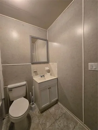 a bathroom with a toilet a sink and mirror