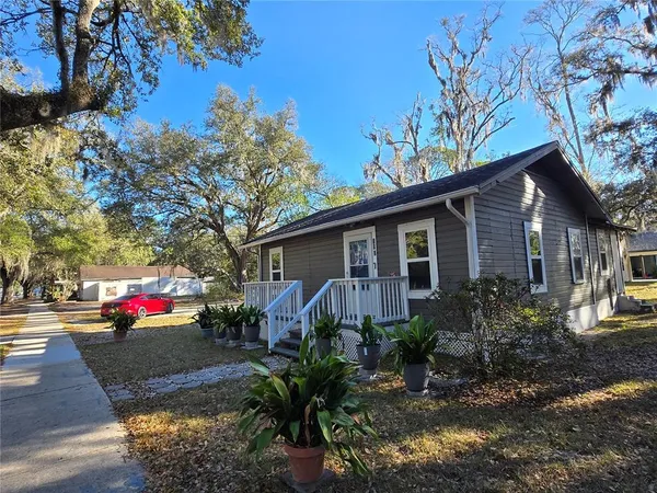 a view of a house with a yard and wooden fence