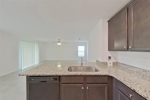 a kitchen with granite countertop cabinets and white appliances