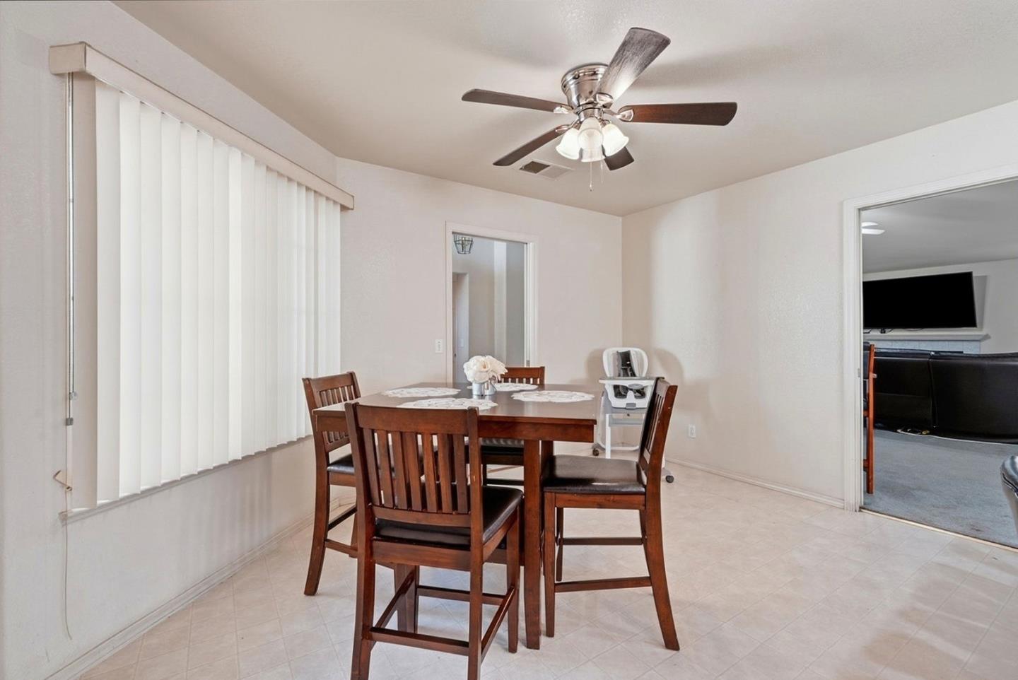 3882 Pintail Court Merced, CA 95340 - Photo 11 of 21 a view of a dining room with furniture and chandelier