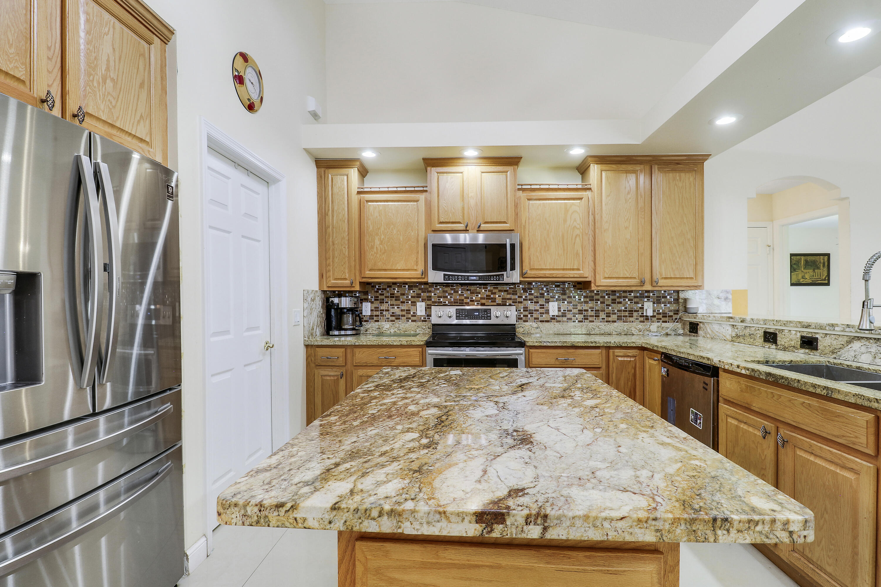 2085 Southwest Aladdin Street Port St. Lucie, FL 34953 - Photo 18 of 45 a kitchen with stainless steel appliances granite countertop a refrigerator sink and stove
