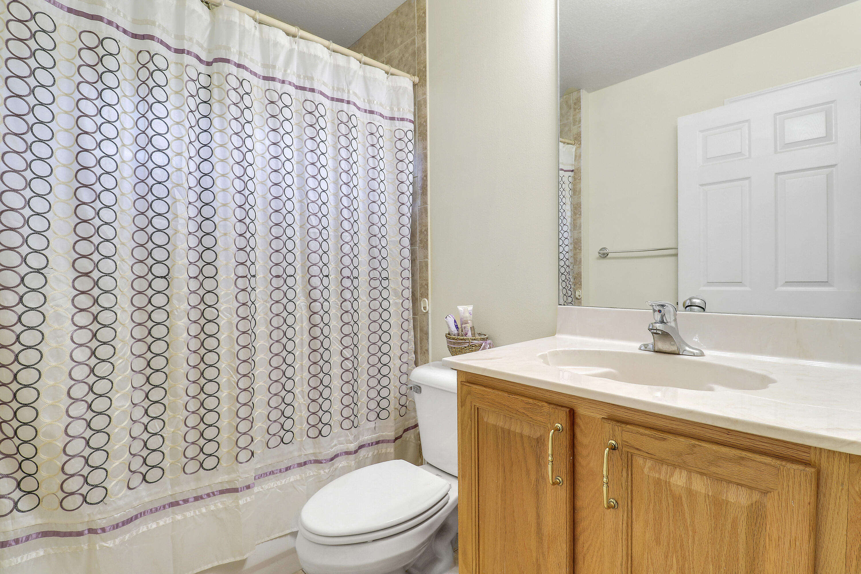 2085 Southwest Aladdin Street Port St. Lucie, FL 34953 - Photo 35 of 45 a bathroom with a granite countertop toilet sink and a mirror