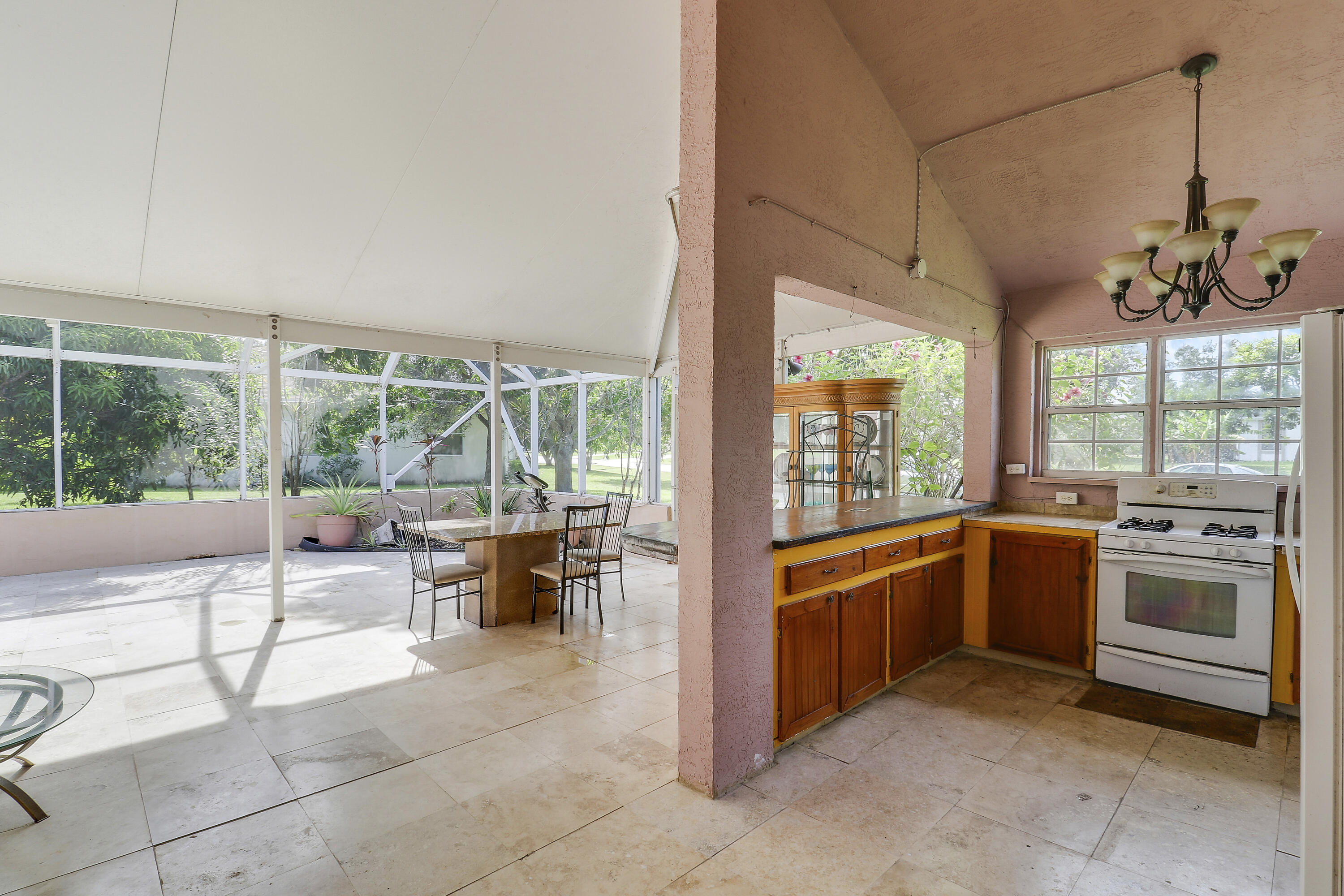2085 Southwest Aladdin Street Port St. Lucie, FL 34953 - Photo 37 of 45 a kitchen with stainless steel appliances granite countertop a stove and a view of living room with a large window