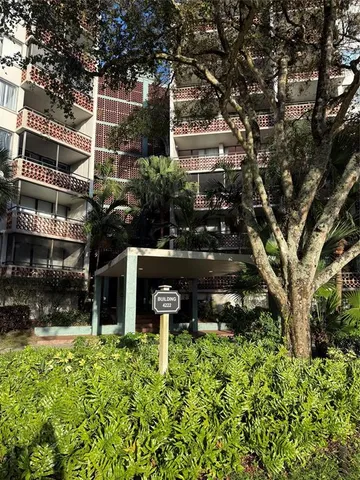 front view of a building with a garden