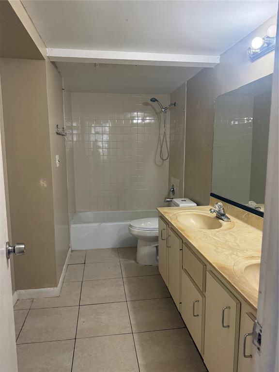 4222 Inverrary Boulevard, Unit 4609 Lauderhill, FL 33319 - Photo 15 of 29 a bathroom with a granite countertop sink a toilet and shower
