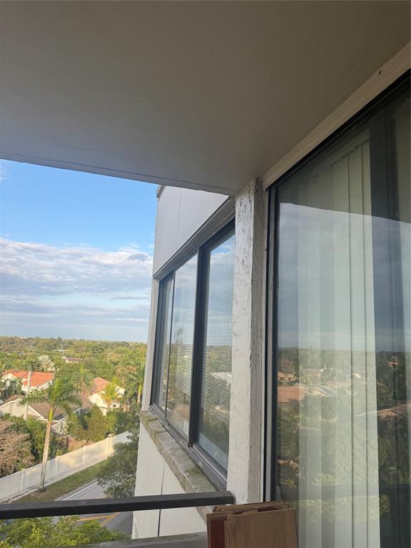 4222 Inverrary Boulevard, Unit 4609 Lauderhill, FL 33319 - Photo 19 of 29 a view of a glass door and a yard from a balcony