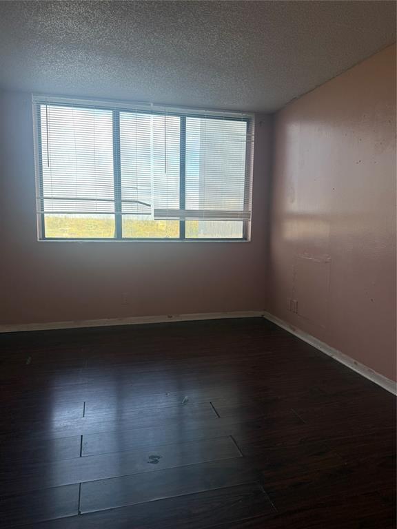 4222 Inverrary Boulevard, Unit 4609 Lauderhill, FL 33319 - Photo 22 of 29 an empty room with wooden floor and windows