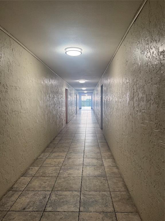 4222 Inverrary Boulevard, Unit 4609 Lauderhill, FL 33319 - Photo 24 of 29 a hallway with view of a bathroom
