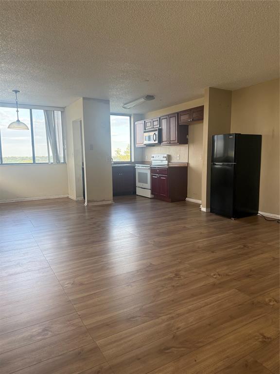 4222 Inverrary Boulevard, Unit 4609 Lauderhill, FL 33319 - Photo 9 of 29 a view of a kitchen with furniture and wooden floor