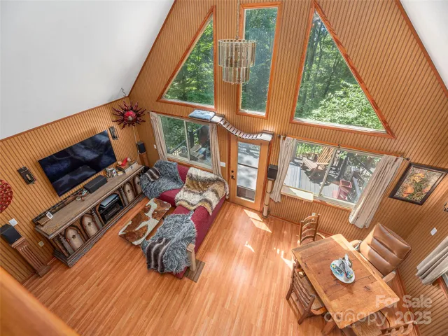 an outdoor living room with furniture and a flat screen tv