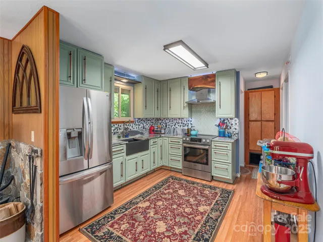 a kitchen with stainless steel appliances granite countertop a refrigerator stove and sink