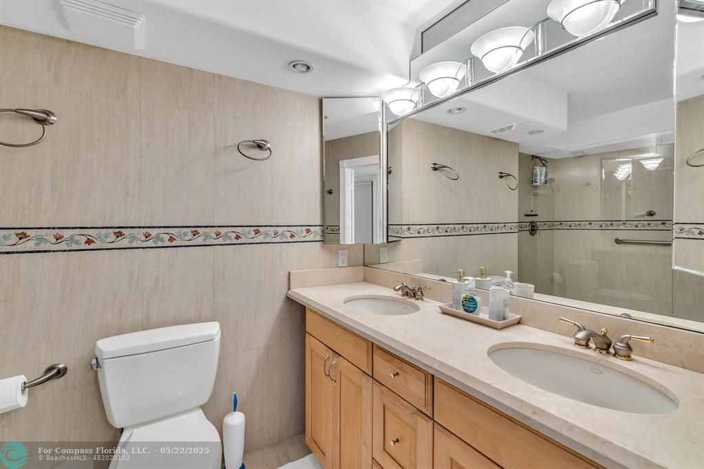 3000 South Ocean Boulevard, Unit 1106 Boca Raton, FL 33432 - Photo 13 of 30 a bathroom with a sink a toilet and mirror