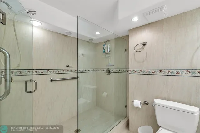 a bathroom with a shower a toilet and a sink
