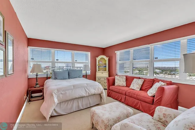 a bedroom with a bed and glass window