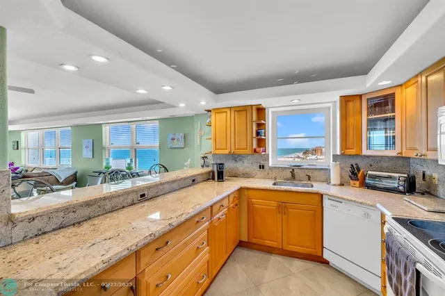 a large kitchen with a sink and cabinets