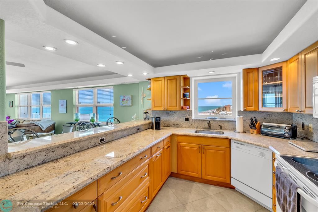 3000 South Ocean Boulevard, Unit 1106 Boca Raton, FL 33432 - Photo 2 of 30 a large kitchen with a sink and cabinets