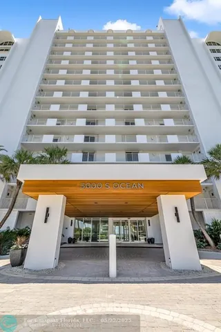 a living room with furniture and flowers