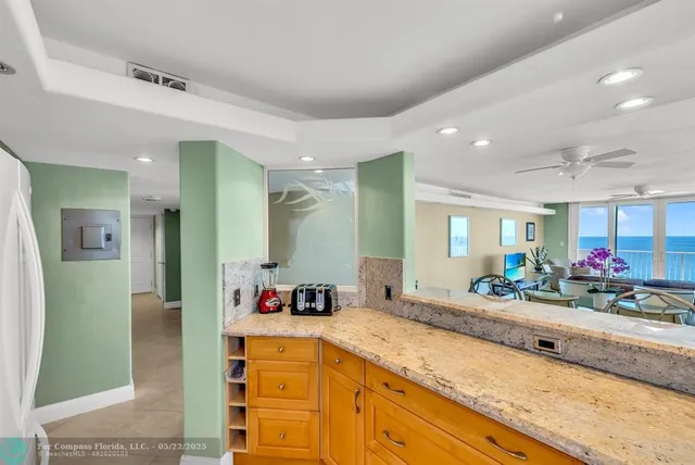 a spacious bathroom with a granite countertop sink and a mirror