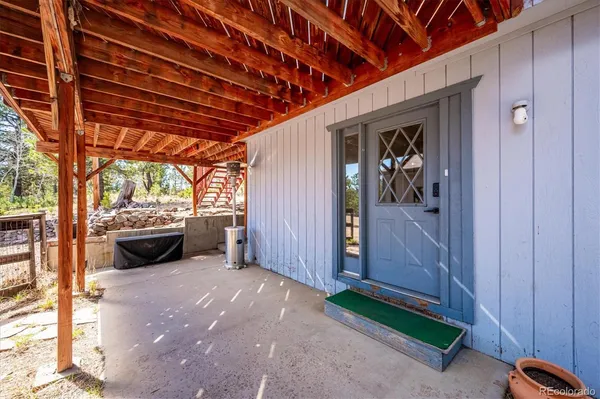 a view of a house with wooden deck front of house