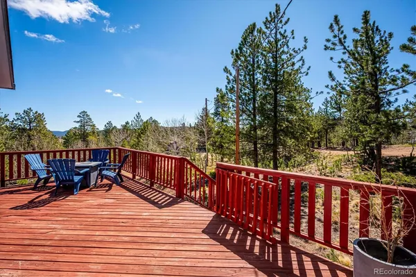 a balcony with wooden floor and outdoor seating