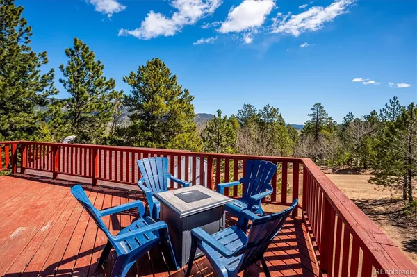 a balcony with table and chairs
