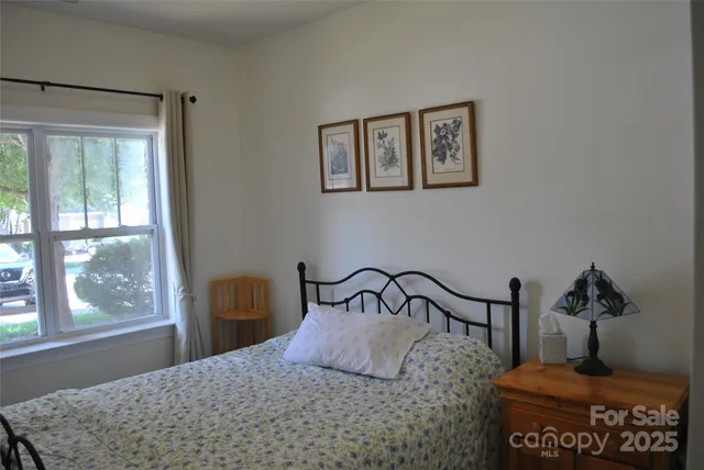 a bedroom with a bed and window