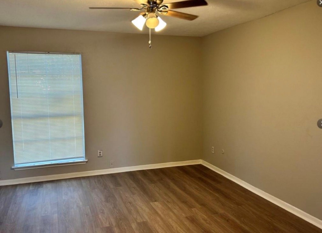 4515 Seneca Street Pasadena, TX 77504 - Photo 12 of 18 an empty room with a window and wooden floor