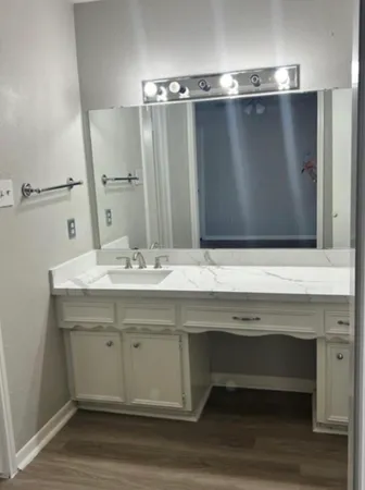 a bathroom with a sink and a mirror
